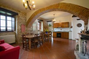 a kitchen and dining room with a table and chairs at Castello di Cisterna in Cisterna