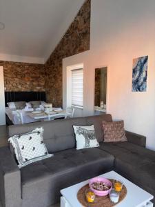 a living room with a couch and a table at N E G R O Apartments - Novalja in Novalja