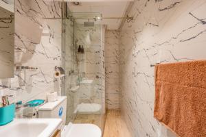 a bathroom with a toilet and a sink and a shower at Madani Palazza Appart & Duplex in Marrakech +65 photos