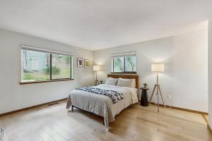 a bedroom with a bed and two windows at Harmony Haven in Groveland +36 photos