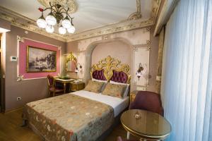 a bedroom with a king sized bed and a table at Phosphorion in Istanbul