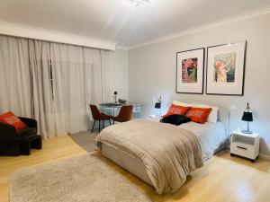 a bedroom with a bed and a table in it at The Yellow Retreat in A dos Cunhados