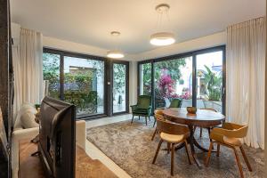 a living room with a tv and a table and chairs at 54 São Paulo - Exclusive Apartment Hotel in Lisbon
