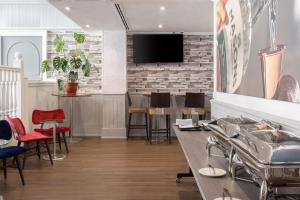 a restaurant with tables and chairs and a tv on a brick wall at Hilton York in York