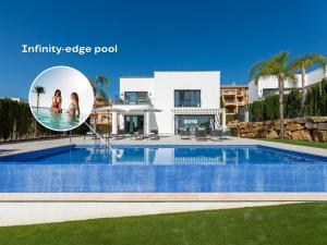 a villa with a swimming pool in front of a house at VACATION MARBELLA I Villa De La Resina, Infinity Pool, Golf Community, Africa Views in Estepona +40 photos
