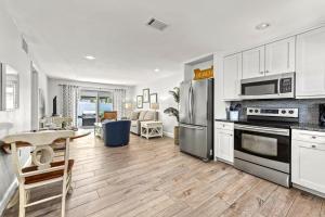 a kitchen with white cabinets and stainless steel appliances at Blue Ocean Suites in Siesta Key