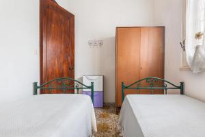 En eller flere senge i et værelse på Villetta Isla Bonita by BarbarHouse