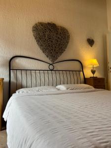 a bedroom with a bed with a heart on the wall at Chalet Giulia in Bezzecca