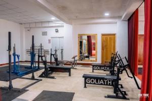 a gym with several treadmills and cardio machines at Riverside Hotel Colombo in Katunayaka