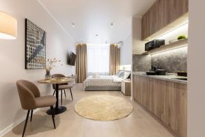a kitchen and a living room with a table at The First Apart Hotel in Almaty