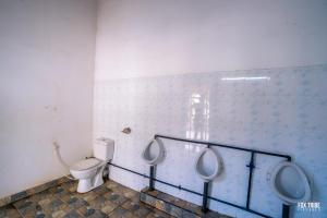 a bathroom with two urinals and a toilet at Riverside Hotel Colombo in Katunayaka +23 photos