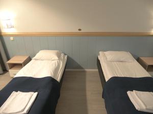 Ένα ή περισσότερα κρεβάτια σε δωμάτιο στο Finlandia Hotel Puu-Juuka