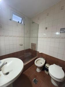 a bathroom with a sink and a toilet and a tub at La Magallanes in Santiago del Estero