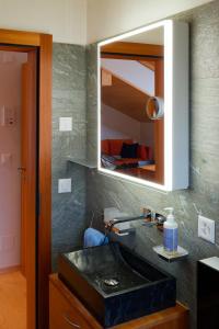 a bathroom with a black sink and a mirror at Chalet Valeria in Saas-Fee