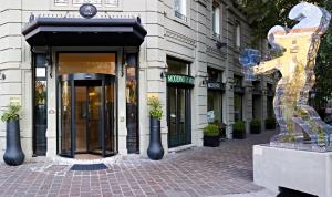a building with a statue in front of it at Hotel Moderno in Pavia