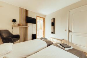 a hotel room with two beds and a chair at Brakši Namiņš in Pērkone