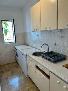 a kitchen with a sink and a counter top at Podaca Holiday House with Sea View in Podaca