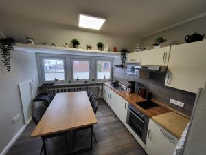 a small kitchen with a wooden table in it at Ferienwohnung Lillian in Bad Zwischenahn