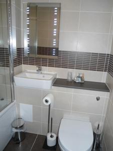 a bathroom with a white toilet and a sink at Park Hotel in Montrose