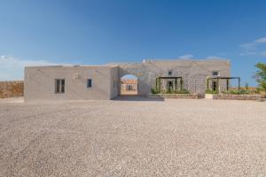 a large stone house with a large driveway at Masseria Vaccaro by Raro Villas - Self Check-in in Brindisi