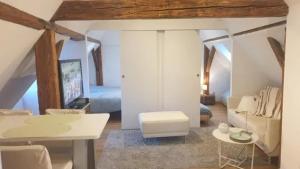 a room with a bed and a table and a couch at Maison spacieuse à Sainte-Croix-en-Plaine avec jardin in Sainte-Croix-en-Plaine