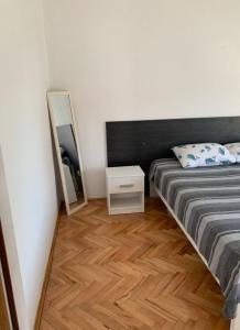 a small bedroom with a bed and a mirror at Sunny in Split