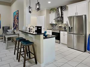 a kitchen with white cabinets and stainless steel appliances at Ferrymans Landing in Aransas Pass