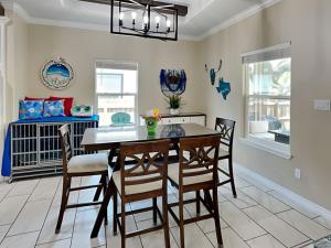 a dining room with a table and chairs and a crib at Ferrymans Landing in Aransas Pass +33 photos