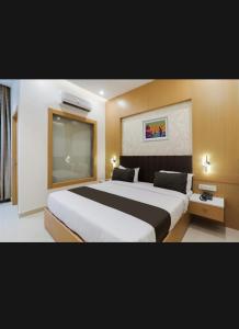 a hotel room with a large bed in it at Raj palace in Lucknow +4 photos