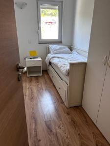 a small bedroom with a bed and a window at Apartment Milna Dante in Milna