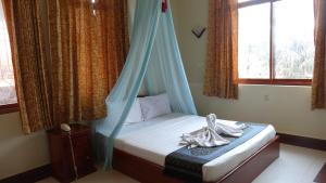 a bedroom with a bed and a window at Golden Noura Villa-Pub & Restaurant in Phnom Penh