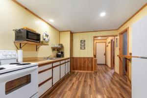 a kitchen with a stove and a white oven at Artilla Cove Cabin 6 -Lake views- Pool & Hot Tub in Branson