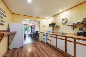 a kitchen with a white refrigerator and a counter at Artilla Cove Cabin 6 -Lake views- Pool & Hot Tub in Branson +21 photos