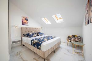 a bedroom with a bed and a chair at Tedoris Apartments in Srima