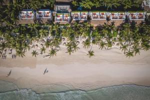 an aerial view of a beach with palm trees at The Beach Tulum Hotel in Tulum
