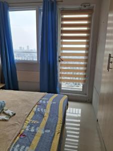 Ένα ή περισσότερα κρεβάτια σε δωμάτιο στο grass residences tower2 21Floor