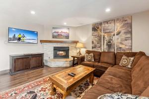 a living room with a couch and a fireplace at Main St Condo with Fireplace & Mountain Views in Breckenridge