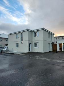 a large white building in a parking lot at Reynisstaðir in Keflavík