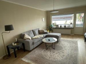 a living room with a couch and a table at Newly renovated, spacious flat! in Uppsala