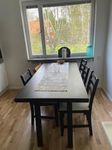 a dining room table and chairs in a room with a window at Newly renovated, spacious flat! in Uppsala +11 photos
