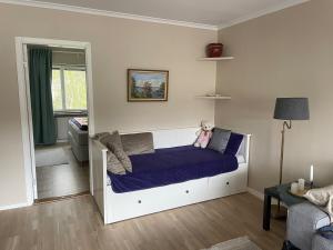a bedroom with a bed with a teddy bear on it at Newly renovated, spacious flat! in Uppsala