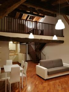 a living room with a couch and a table and chairs at Via Pepoli Apartments in Bologna