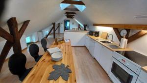 a kitchen with white cabinets and a wooden floor at Nice apartment on the 1st floor in Aabenraa