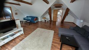 a living room with a couch and a tv at Nice apartment on the 1st floor in Aabenraa
