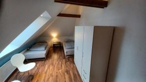 a room with a staircase with a bed and a cabinet at Nice apartment on the 1st floor in Aabenraa