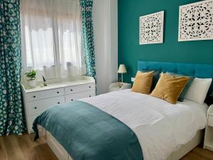 a blue bedroom with a bed and a blue wall at Casa Hoyo 19 in Masía Aldamar +41 photos