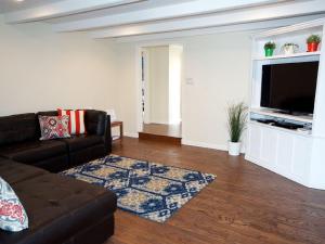 a living room with a couch and a flat screen tv at F-30 Small World in Anaheim