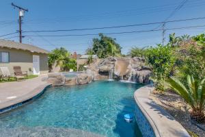 a swimming pool with a waterfall in a backyard at F-30 Small World in Anaheim