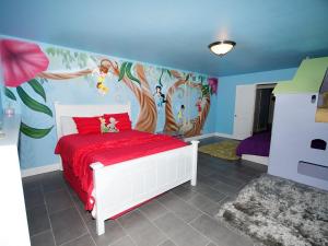 a bedroom with a bed with a painting on the wall at F-24 Mickeys House in Anaheim +31 photos