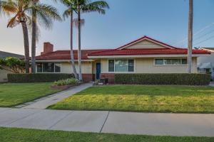 a house with palm trees and a sidewalk at F-24 Mickeys House in Anaheim
